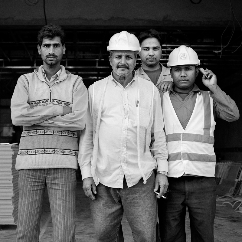 Innominate -  Foremen at a construction site.     