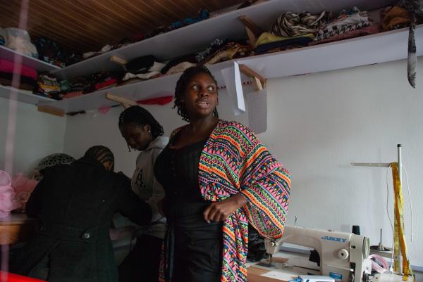 Image from Fashioning a Business - Motapwa Ismaila-Azinge, looks on in the distance while...