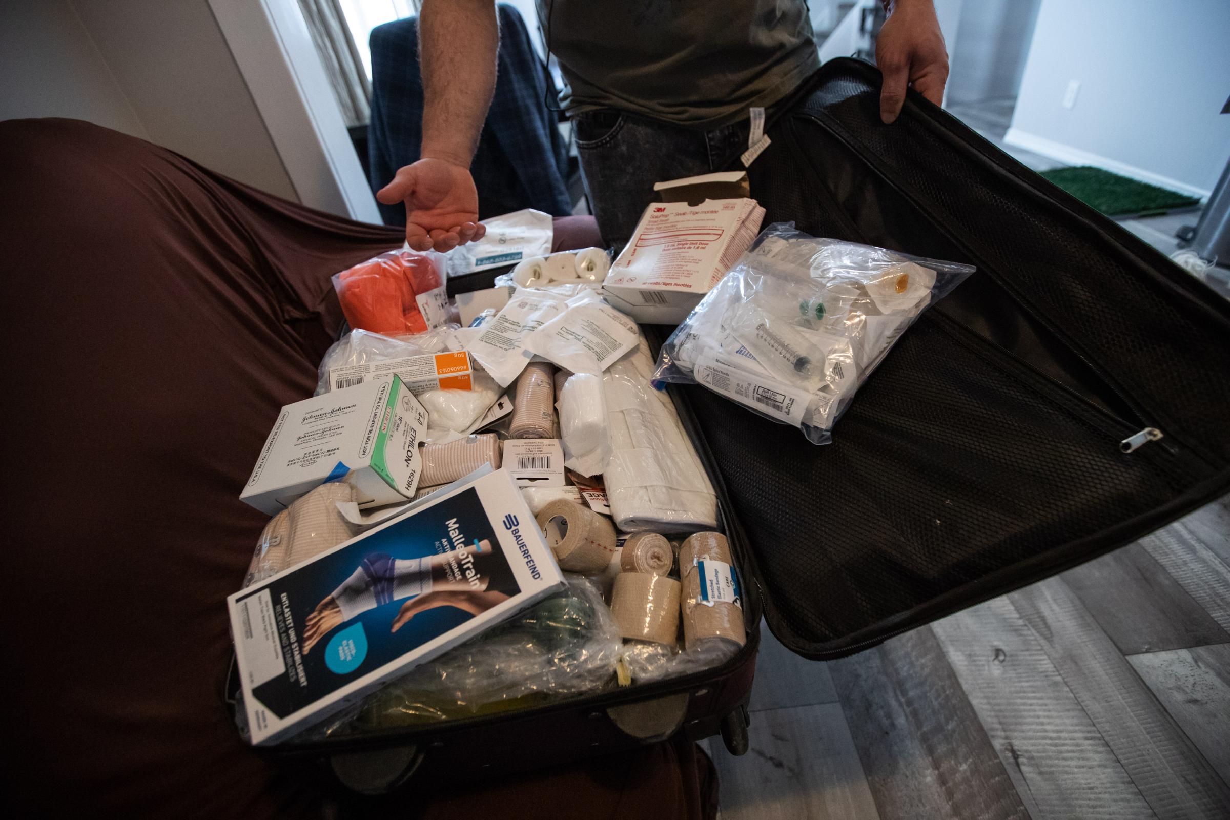 Vartan Davtian, reveals a suitcase packed with donated medical supplies he is taking with him as he travels from his home in Brandon, Manitoba, to...