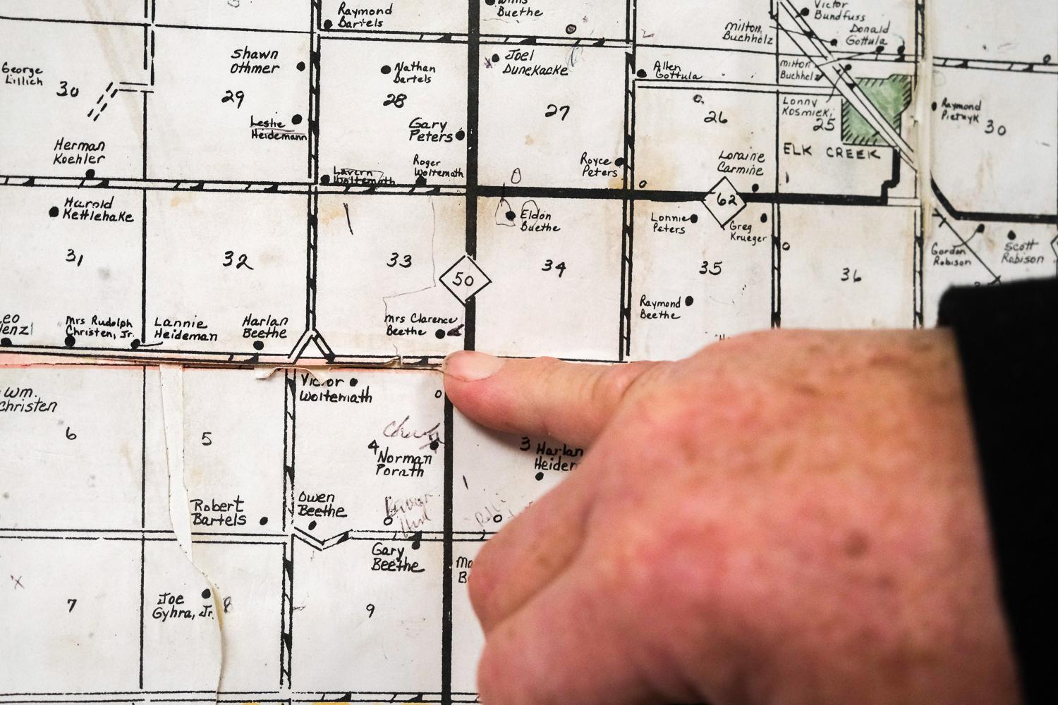The New York Times - Lavon Heidemann shows the location of the mining site on...