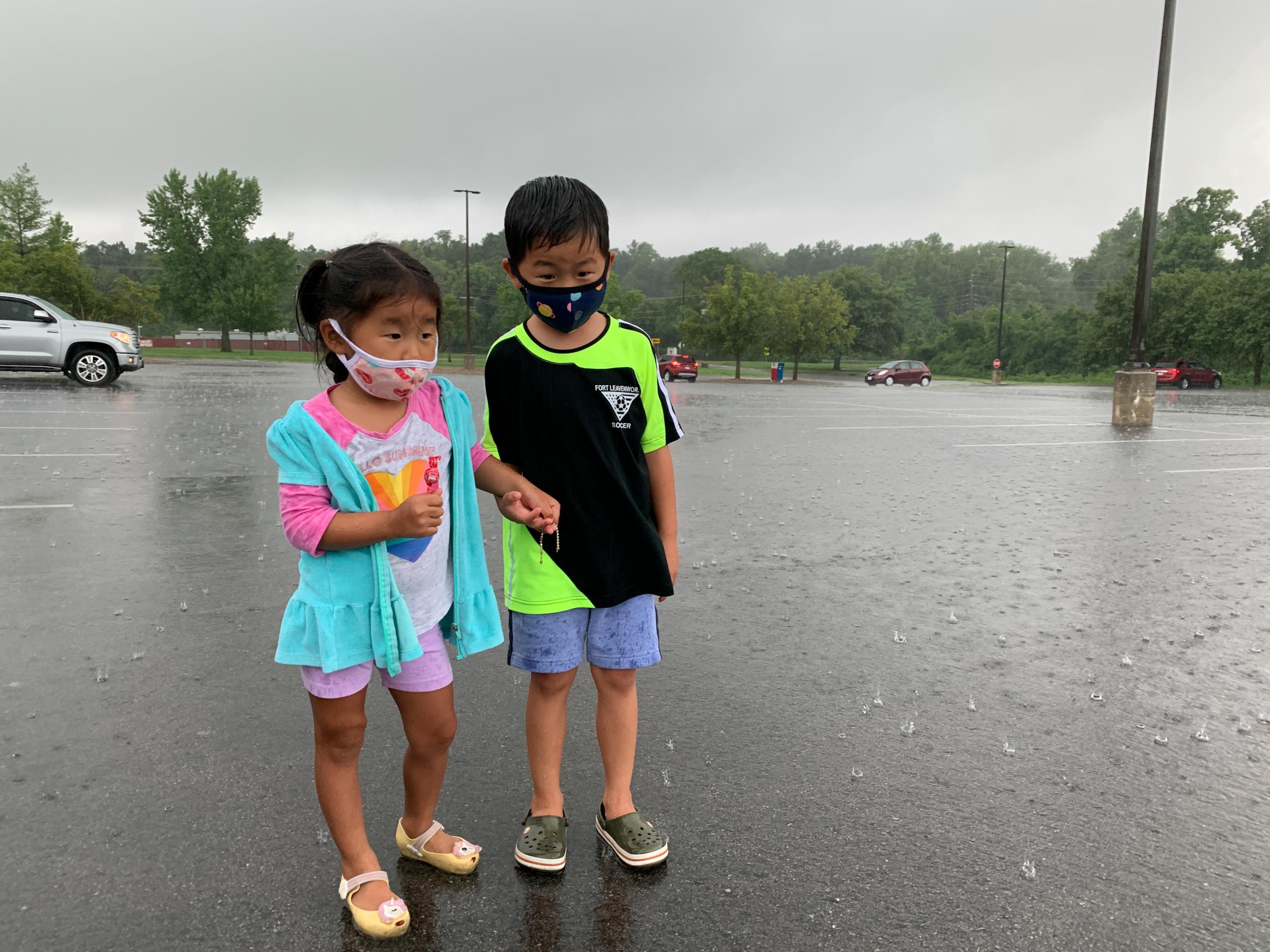 Here, With You - My children stand in the rain in the parking lot of the Post Exchange on July 29, 2020 in Fort...