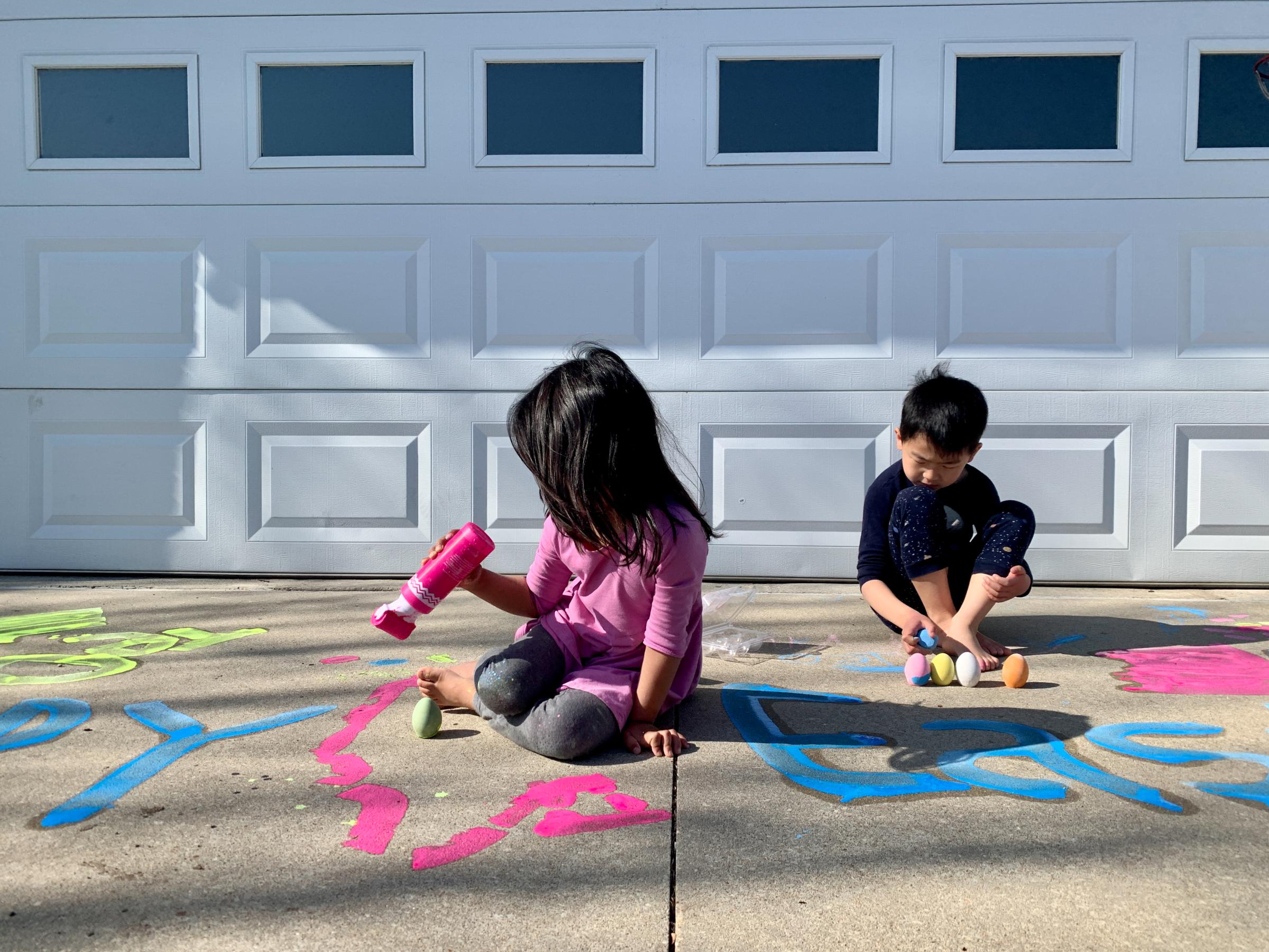 Here, With You - My children play with chalk paint in the driveway on April 4, 2021 in Fort Leavenworth,...