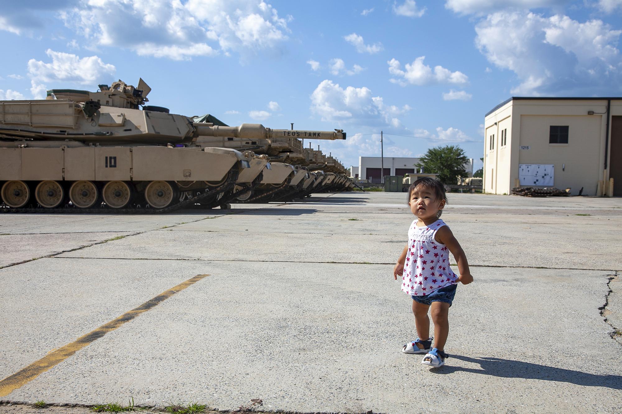 Here, With You - Mila stands in front the bradleys in the motor pool before her dad&#39;s deployment on...