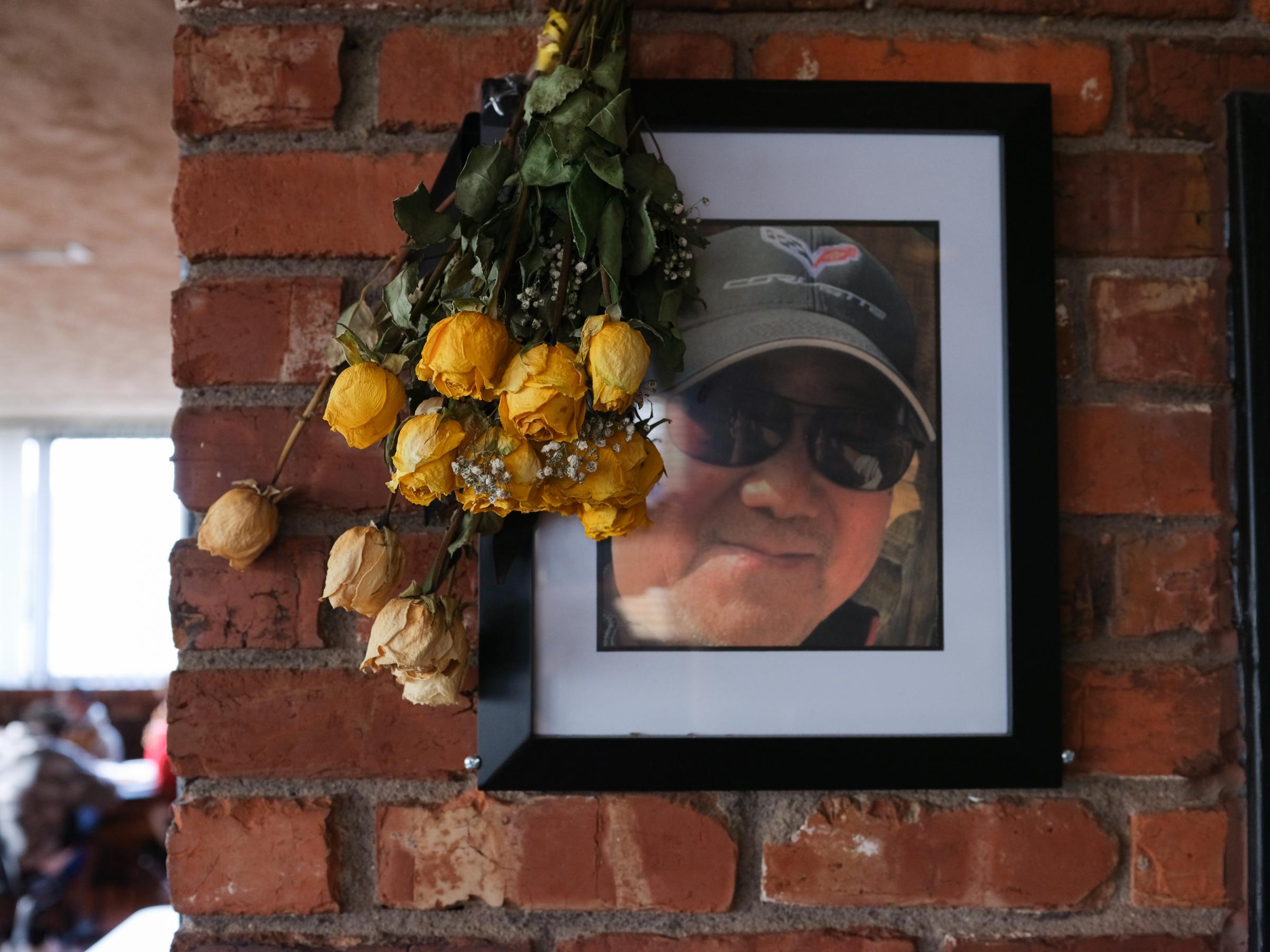 PAPILLION, NE - MARCH 18, 2022: Ming Wang&#39;s portrait hangs next to dried yellow flowers from Ming Wang&#39;s funeral inside of Ming&#39;s Restaurant in Papillion, Nebraska on March 18, 2022. (Photo by Arin Yoon for The Washington Post) Papillion United States