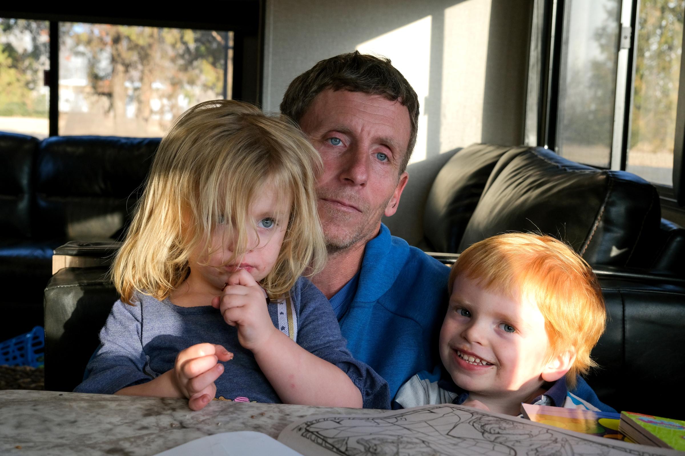 Floyd Bledsoe and his children Brynlee and Bryce pose for a portrait in their home in Hutchinson, Kansas, USA on January 15, 2022. Assignment code 20220115InnocentMan Hutchinson USA