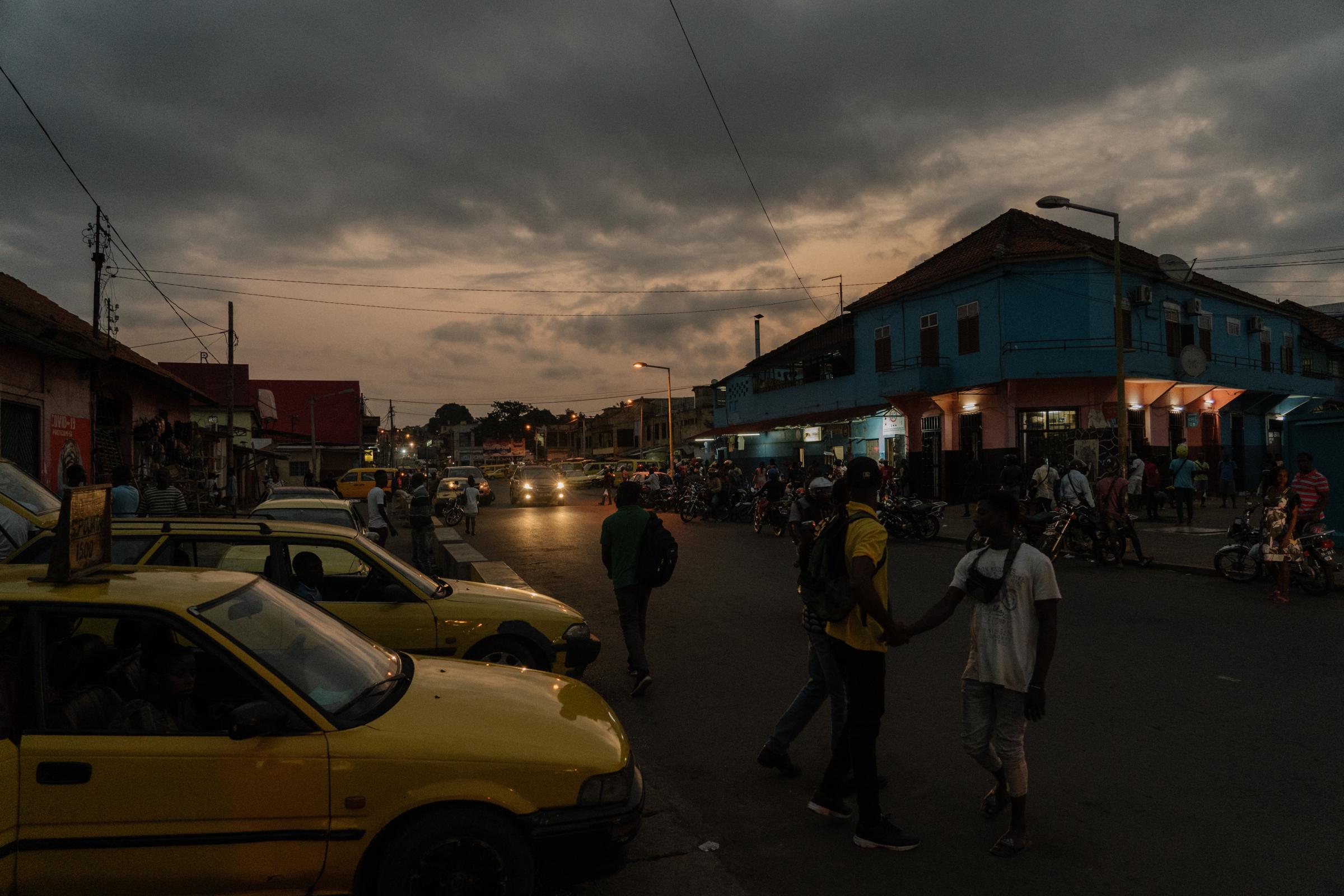 Genetic Engineering In the Mosquito War - Yello taxis lined up in São Tomé city, the...