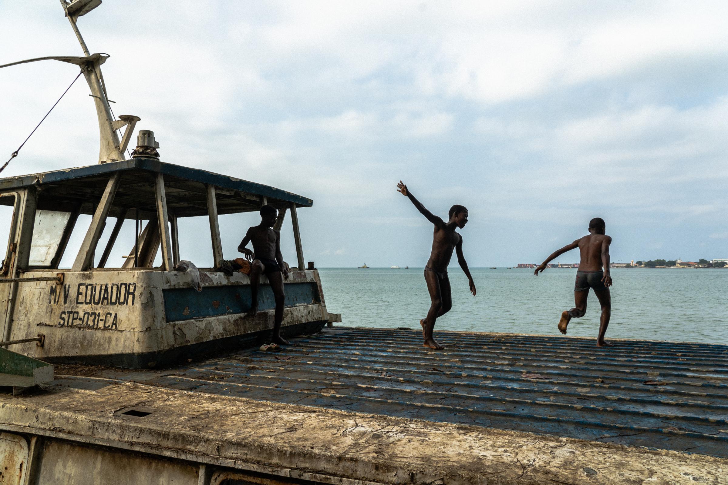 Genetic Engineering In the Mosquito War - Kids play on the abandoned rusty boat before jumping into...