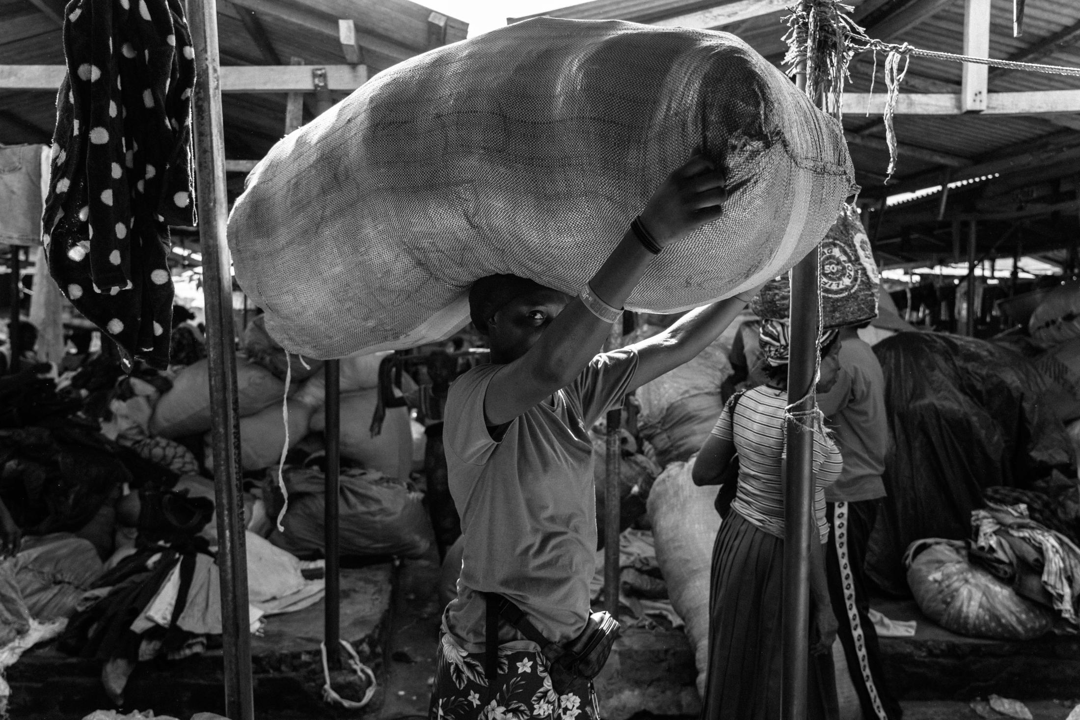 Amina, a kayayei at Accra&r...ast trade in discarded fashion.