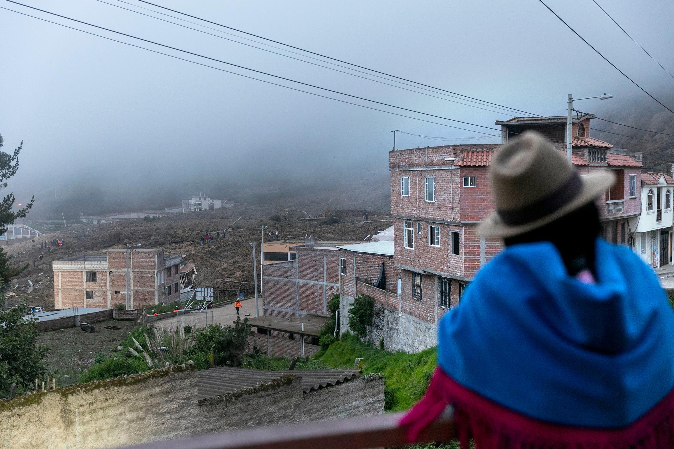 Landslide in Alausí, Chimborazo - For Reuters - An indigenous woman observes from a bridge the landslide...