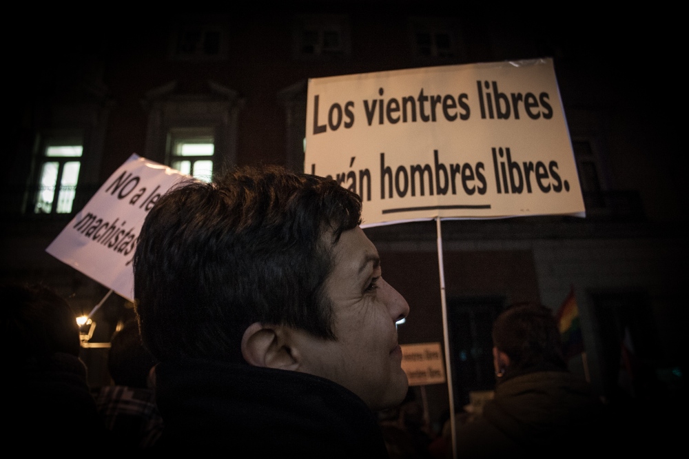  SPAIN. A woman and a sign read...ent, which approved the draft. 