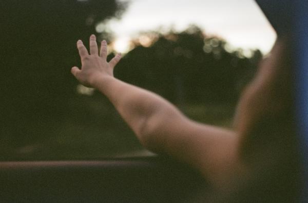 Rebecca hangs her hand out the window as we drive home at sunset. Aguacate United States (USA)