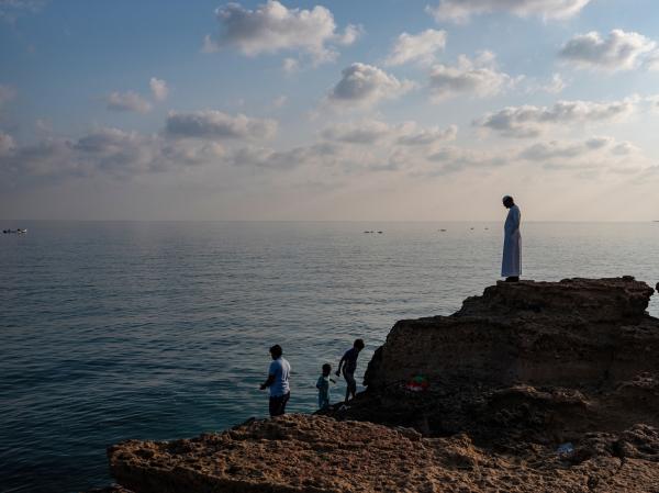 In Oman, a Dagger Symbolizes National Pride - SUR, OMAN-&shy;‐ NOVEMBER 22, 2022: Residents of Sur fishing early morning in the Arabian...