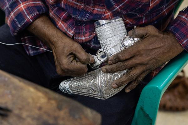 In Oman, a Dagger Symbolizes National Pride - SUR, OMAN-&shy;‐ NOVEMBER 21, 2022: Silver threading of a khanjar being made at Al Sayegh...