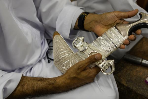 In Oman, a Dagger Symbolizes National Pride - SUR, OMAN-&shy;‐ NOVEMBER 21, 2022: Abdullah Al Farsi of Al Sayegh Silversmithing with a...