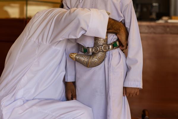 In Oman, a Dagger Symbolizes National Pride - SUR, OMAN-&shy;‐ NOVEMBER 21, 2022: Abdullah Al Farsi of Al Sayegh Silversmithing ties the...