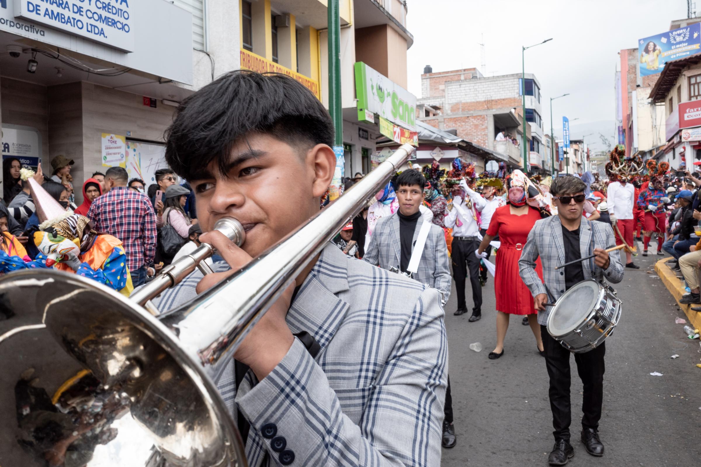 Los Diablos de Píllaro - The band marches along the procession route in...