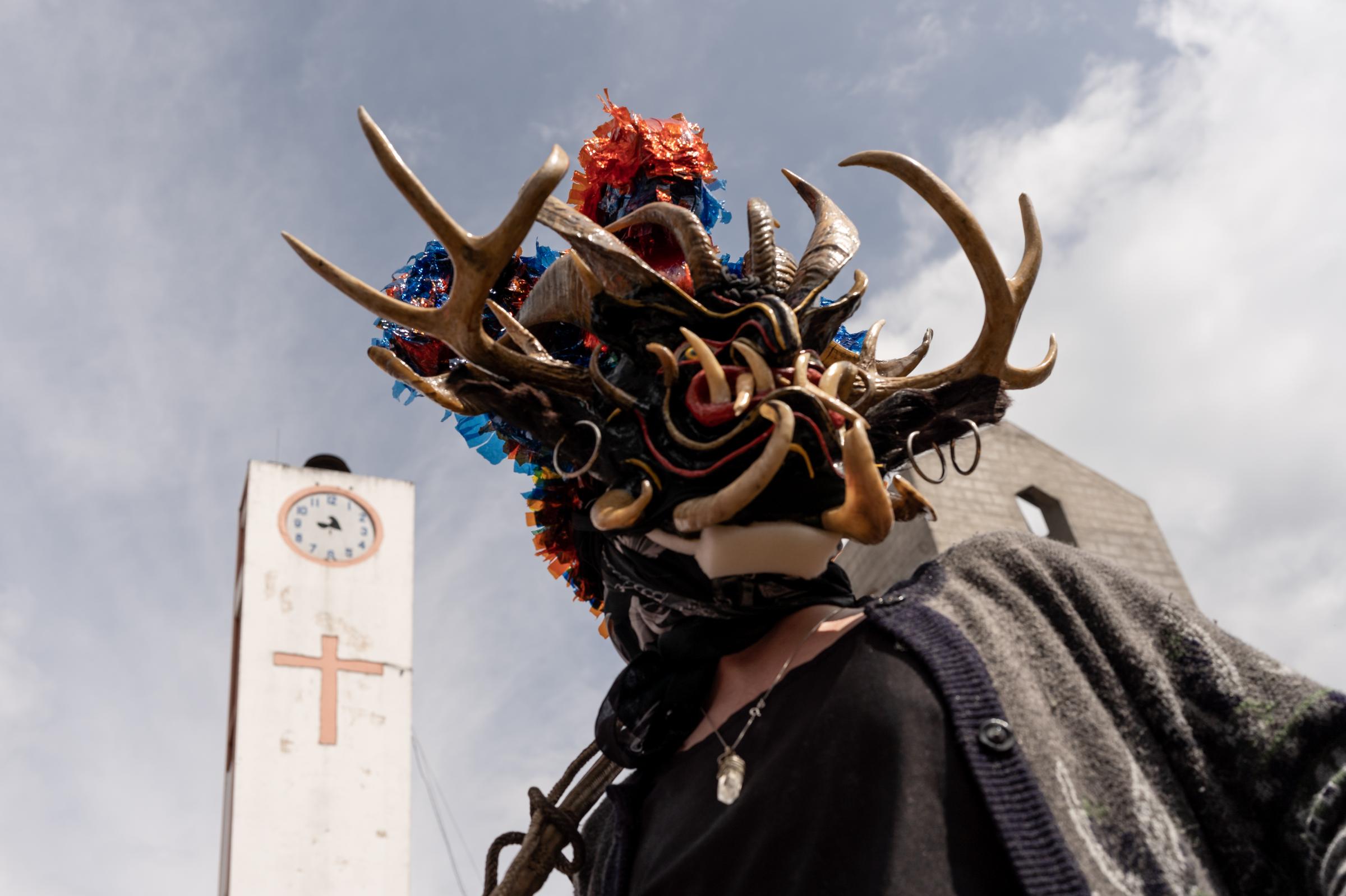 Los Diablos de Píllaro - A devil passes by the local church along the procession...