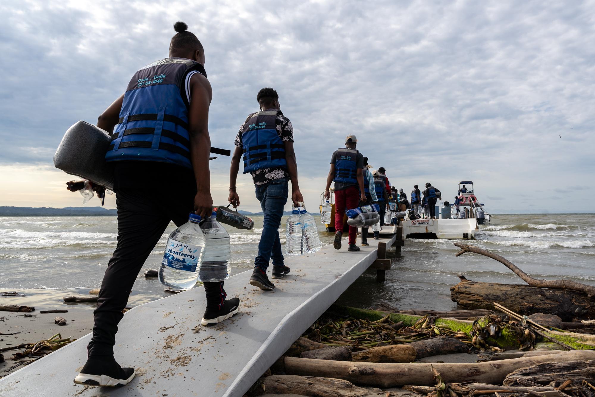 Inside The Derian Gap - Haitian migrants board a boat that will take them across...