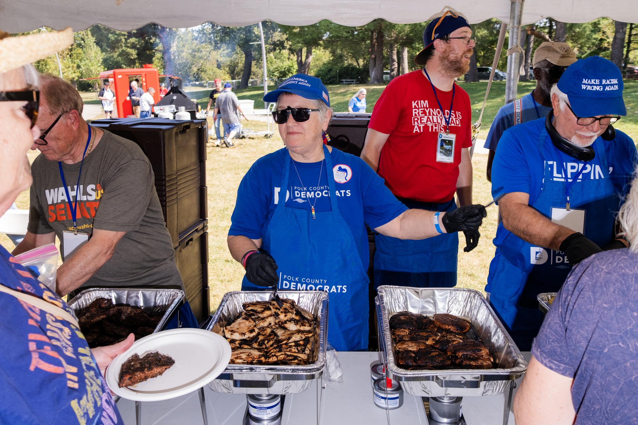 Polly Antonelli serves meat at ...s for The Banner Des Moines USA