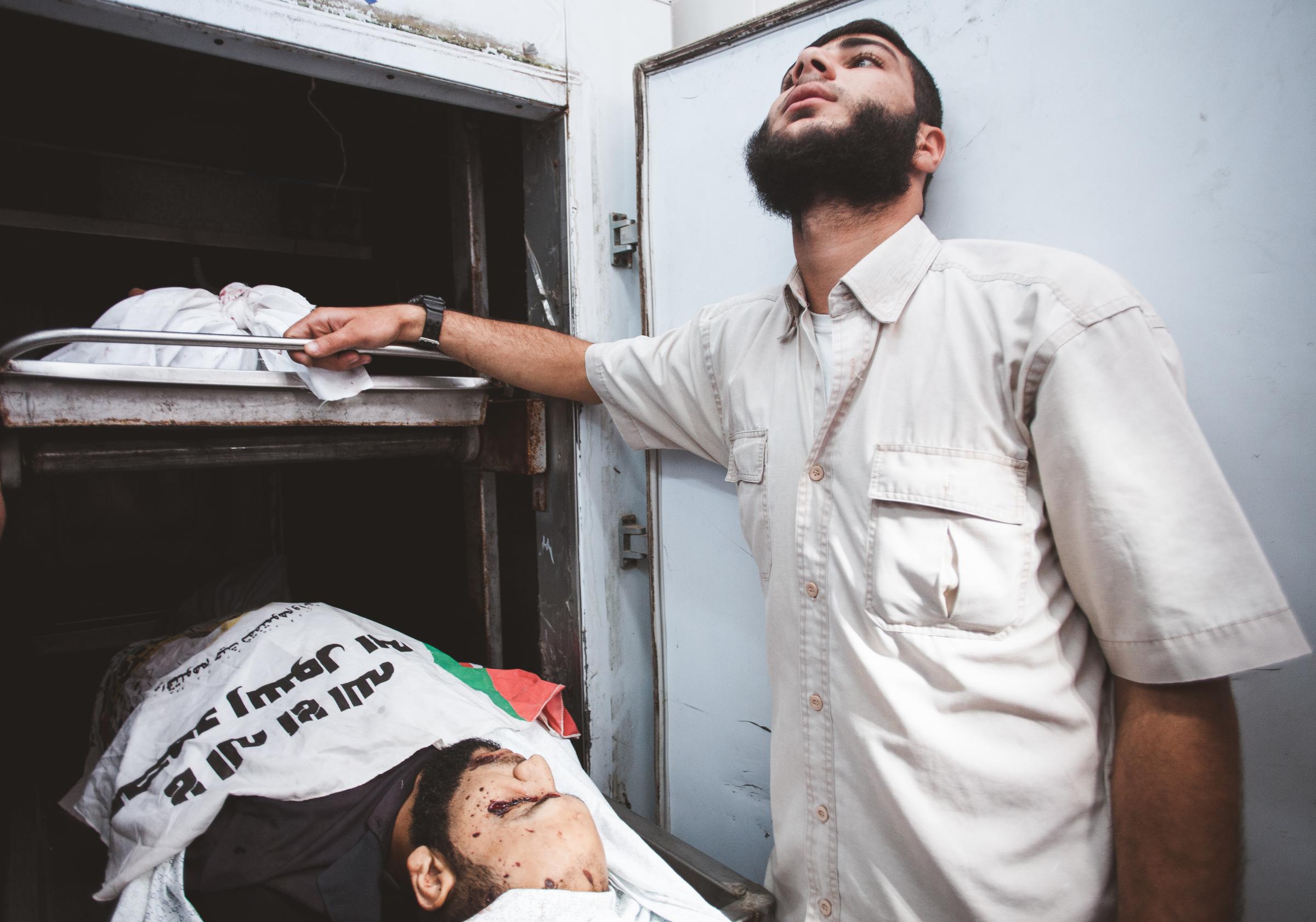 Gaza War 2014 - Palestinian man mourrns over the body of Mazen al-Jarba,...