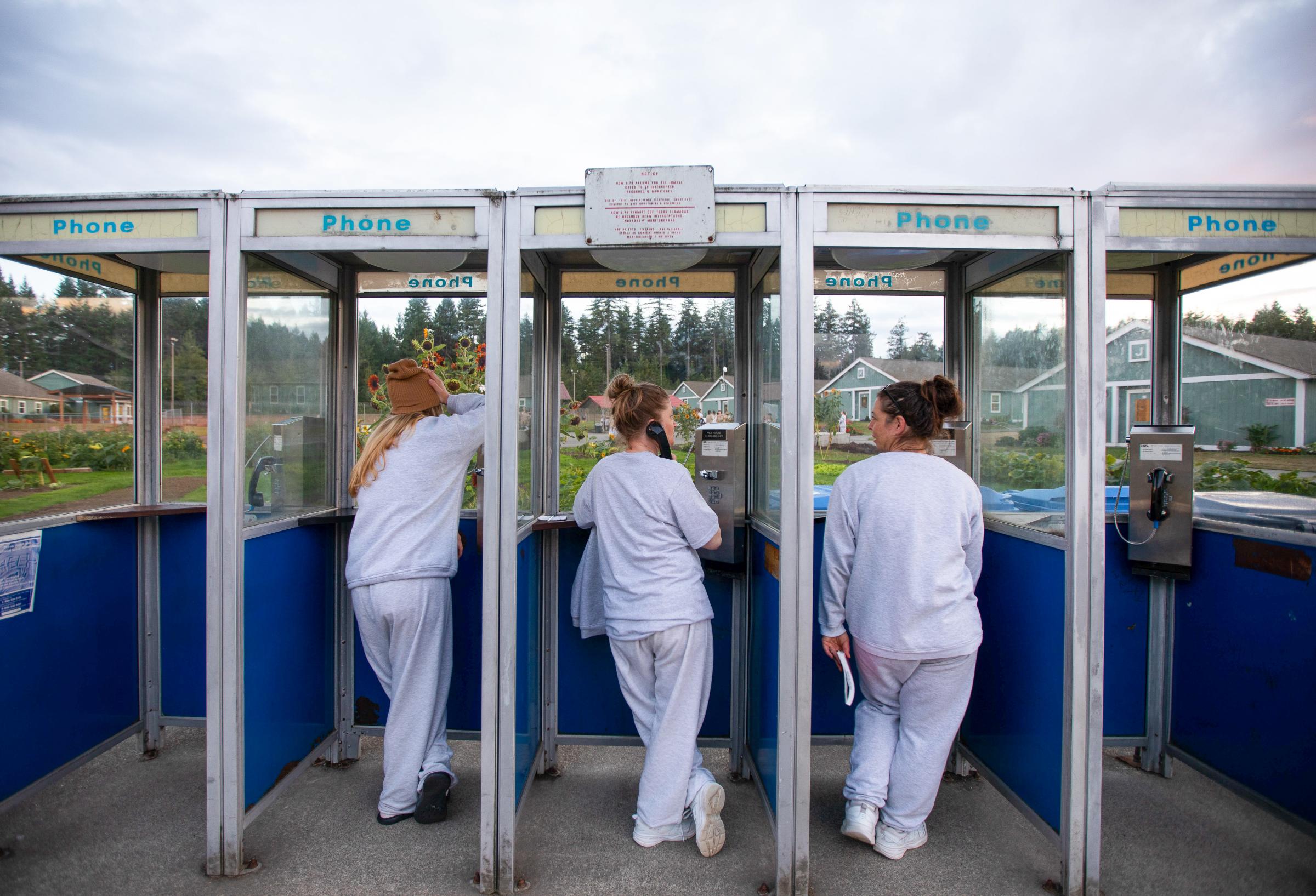 Inmates using the payphone booth outside the Women&#39;s residential parenting building at...