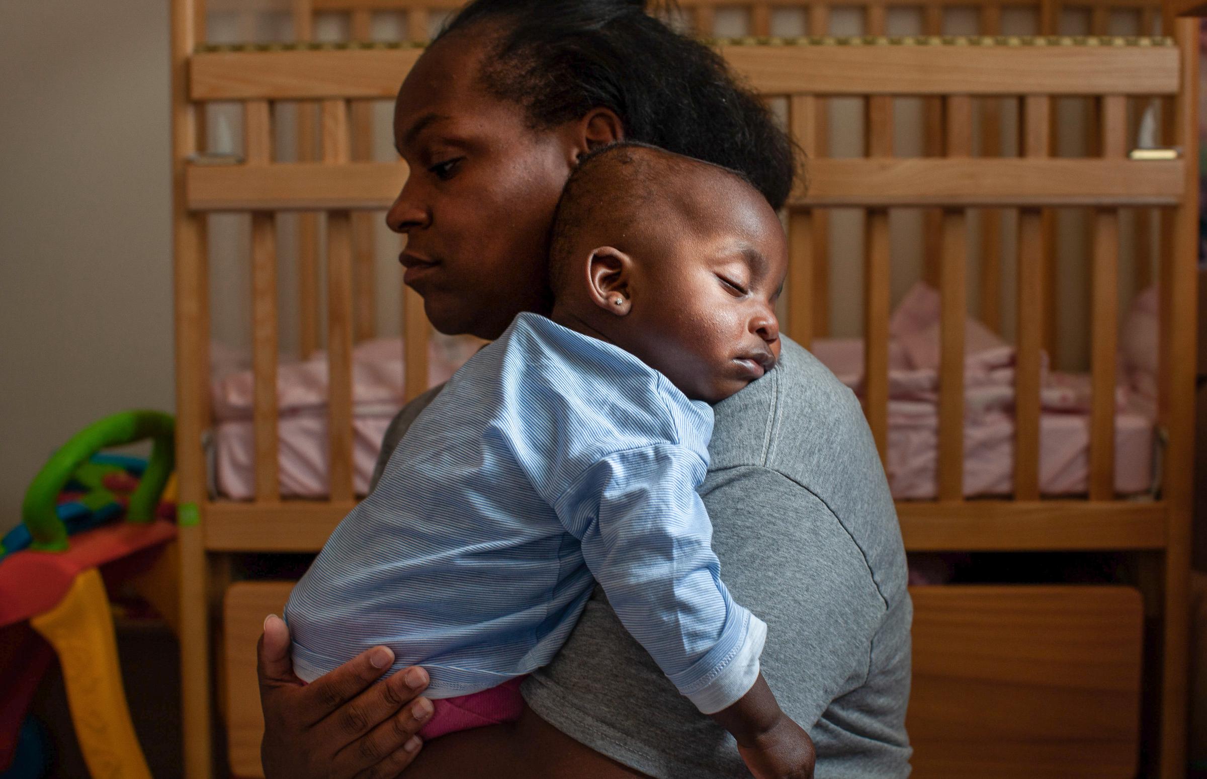 Daidre Kimp holding her daughter Stella (8 mo )as she falls asleep inside her cell at the...
