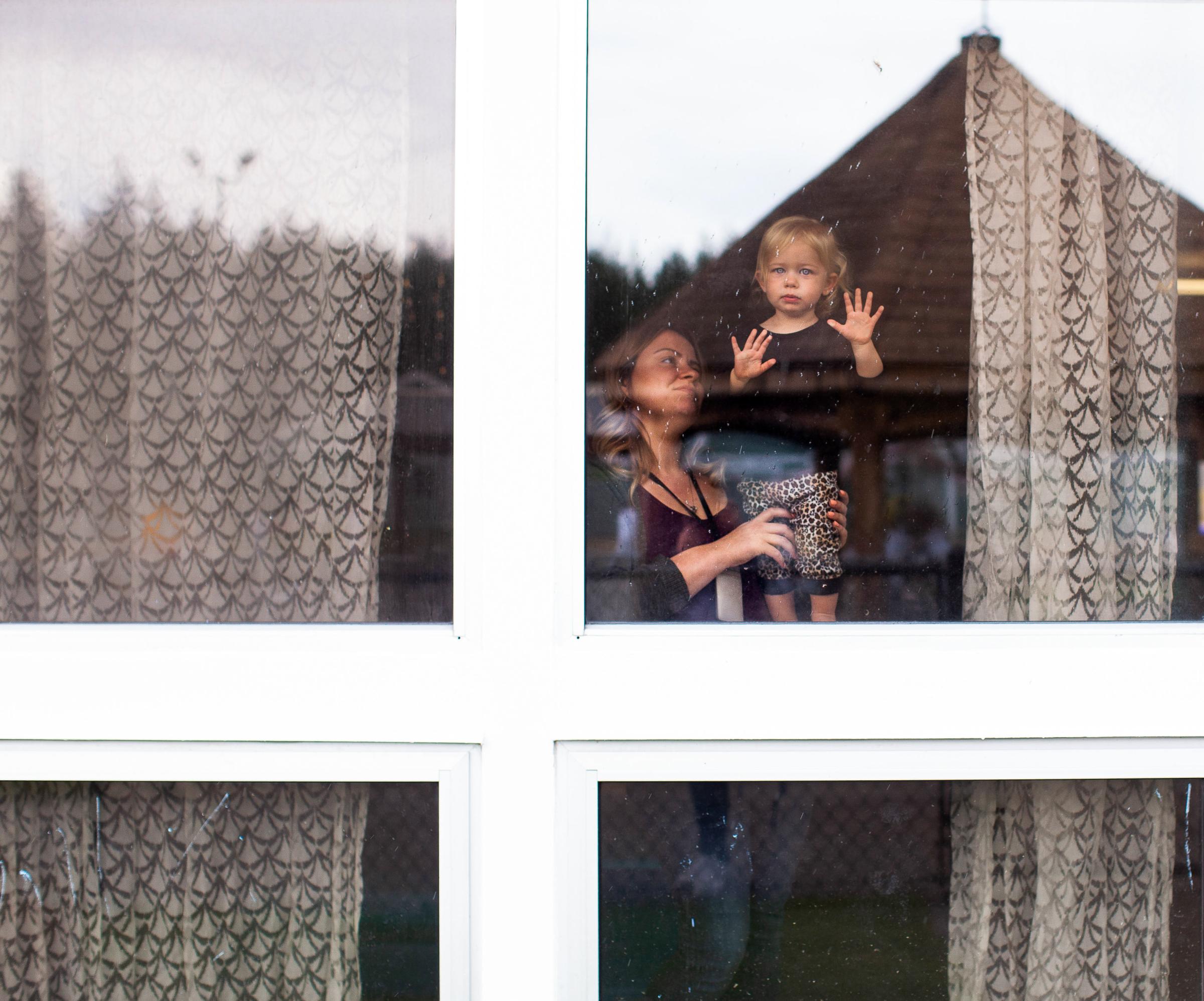 Babies Behind Bars - Charlee Hamilton (1 yr) is standing by the window in her...