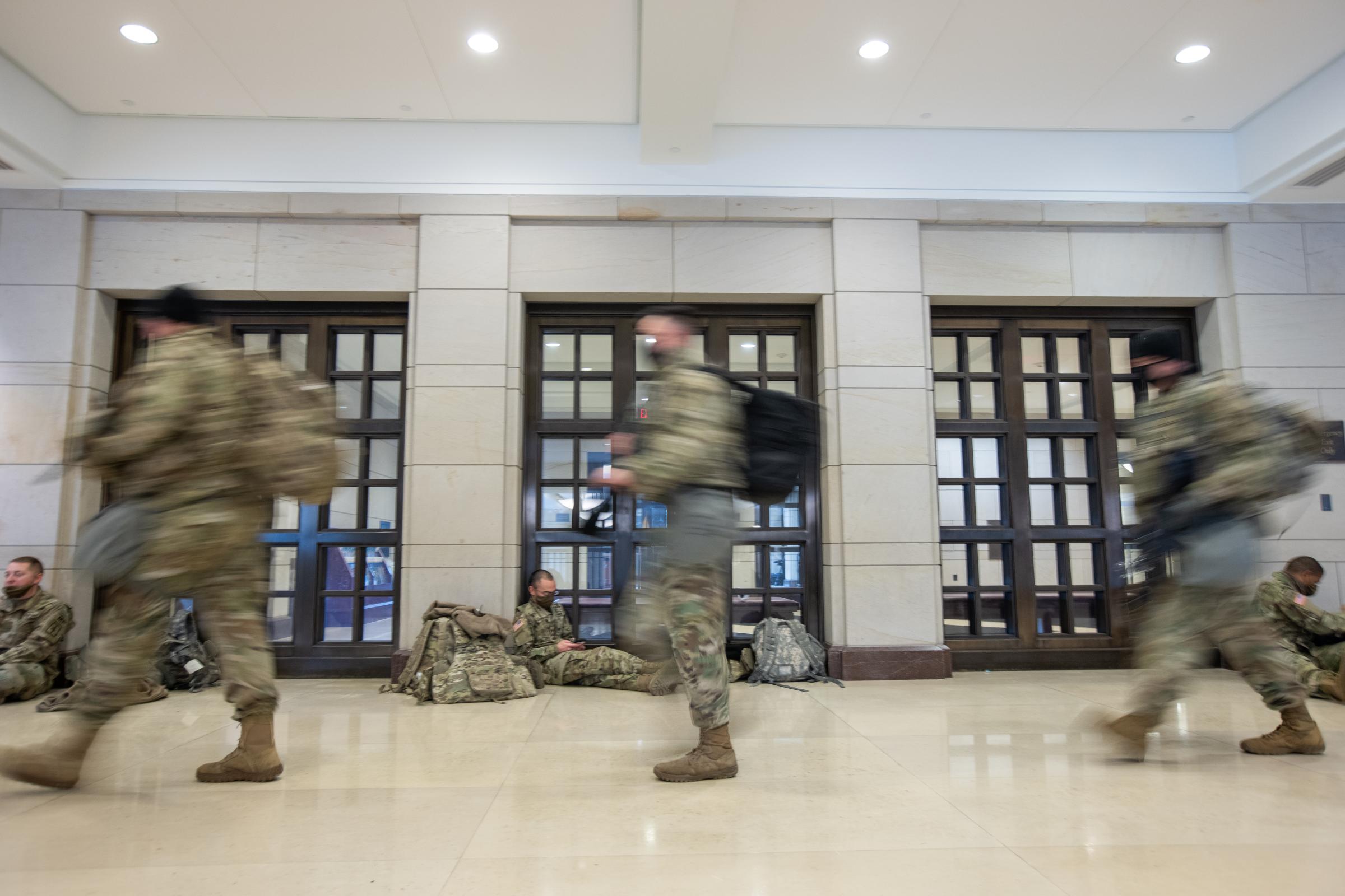 Members of the National Guard take a rest in the visitor&#39;s center on Capitol Hill in...