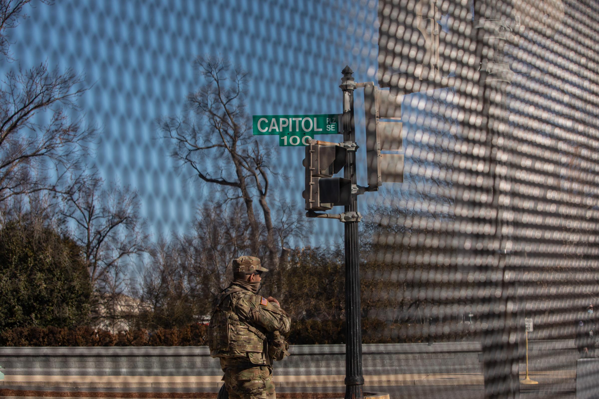 A National Guard standing behind the fence surrounding the U.S. Capitol on Capitol Hill in...