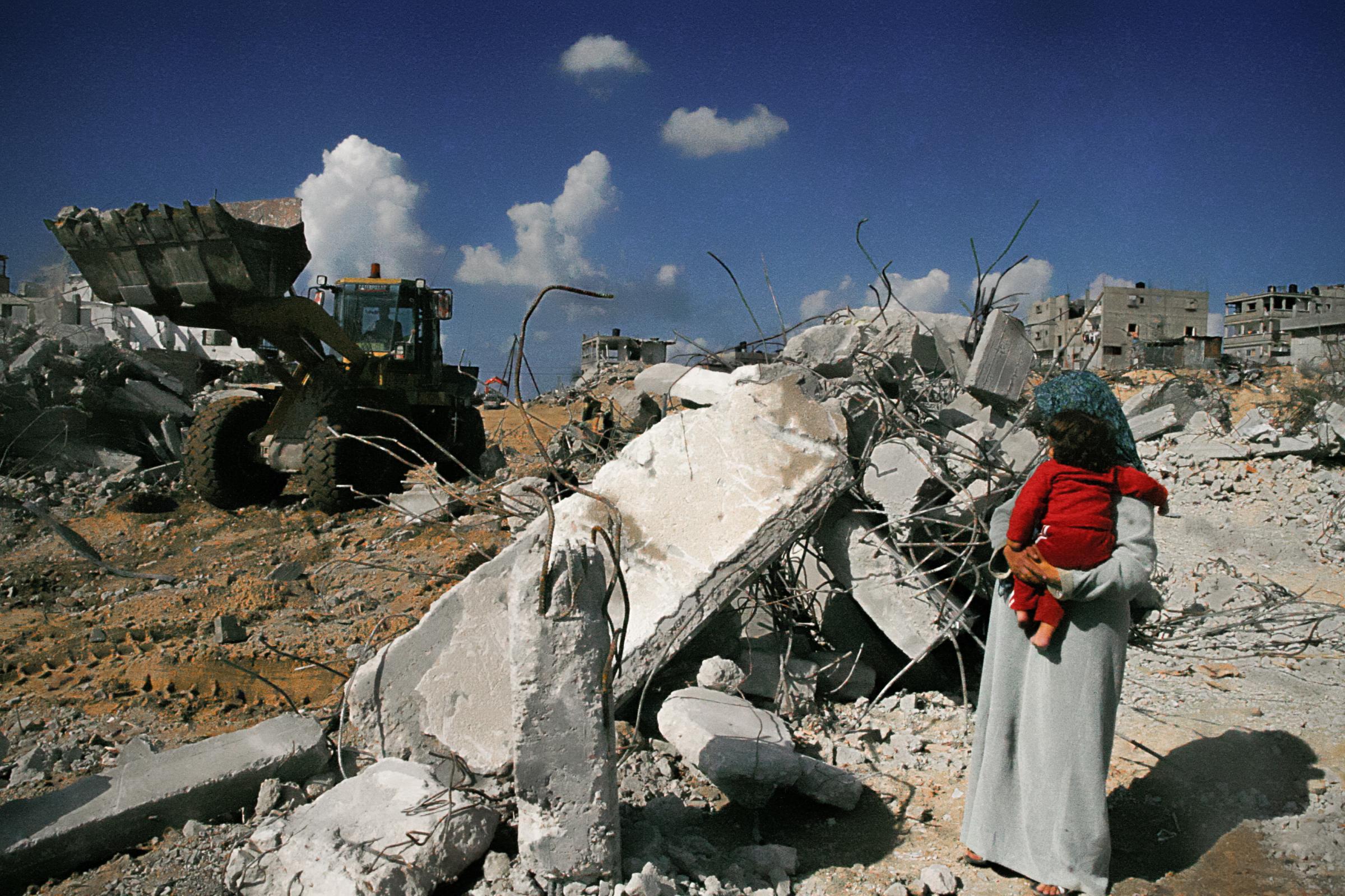 What Lies Beneath The Rubble  - GAZA STRIP, PALESTINE. Ebtesam Khader holding her...
