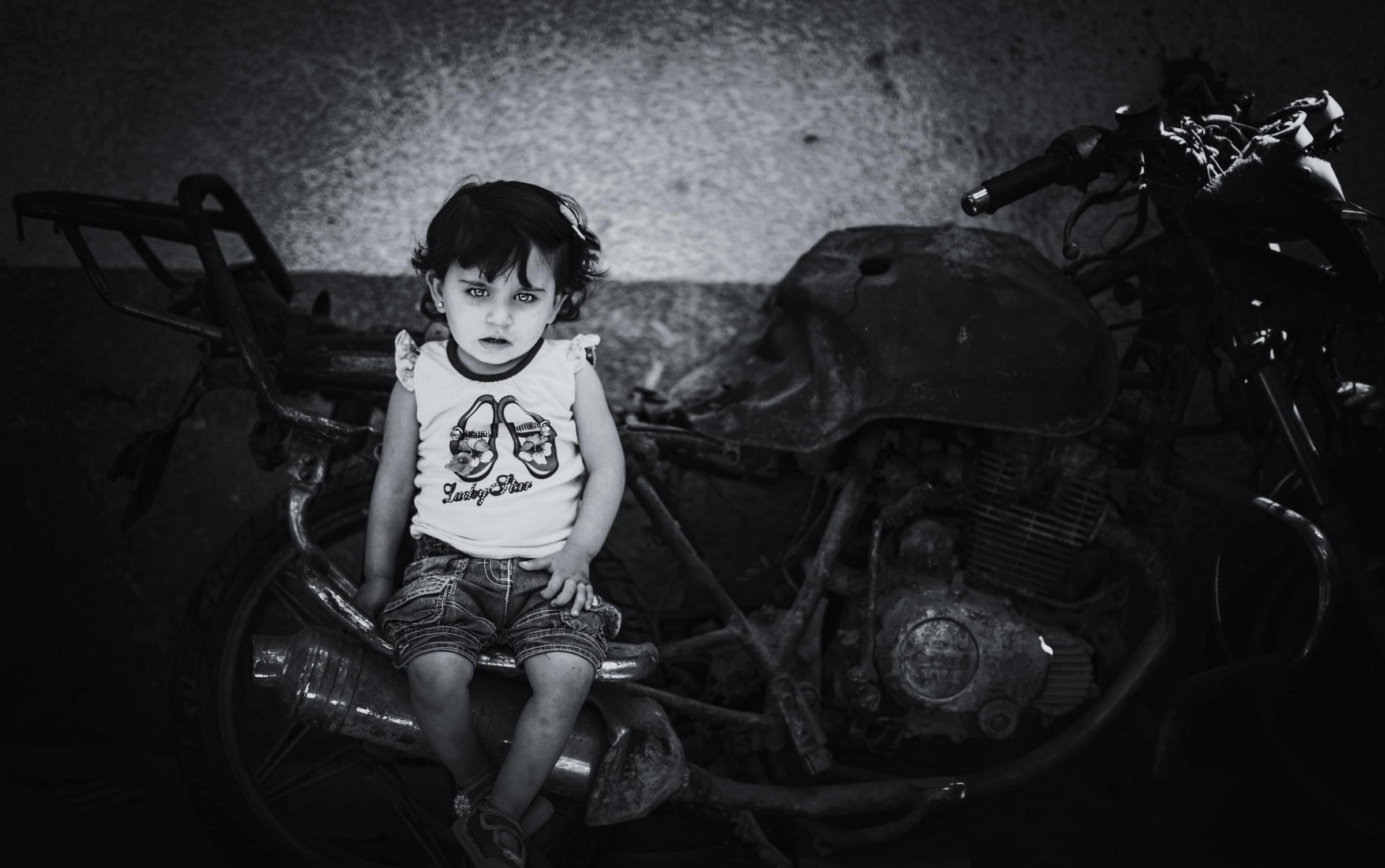 Broken souvenirs -  Islam Qreqe, 14 months old, sitting on a burnet...