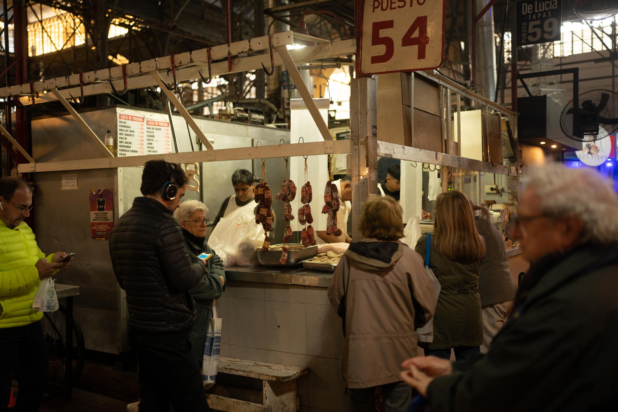 Argentina Inflation  - A line of people waits to make purchases at a butcher...