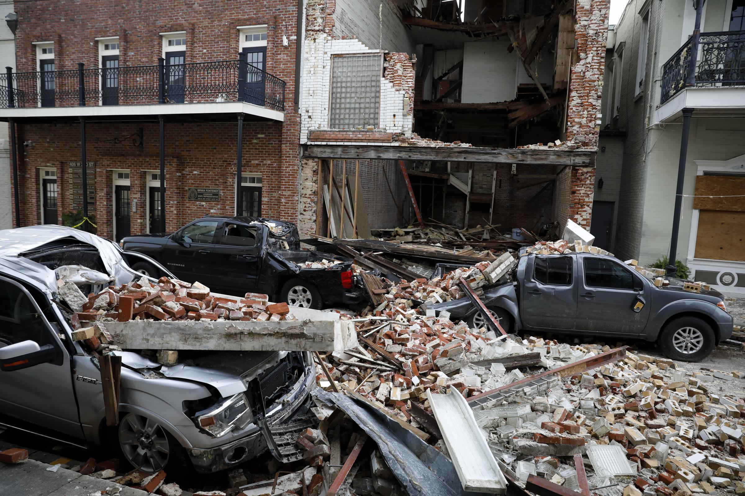 slideshow - Destroyed cars are seen under debris from a collapsed facade after Hurricane Ida made landfall in...