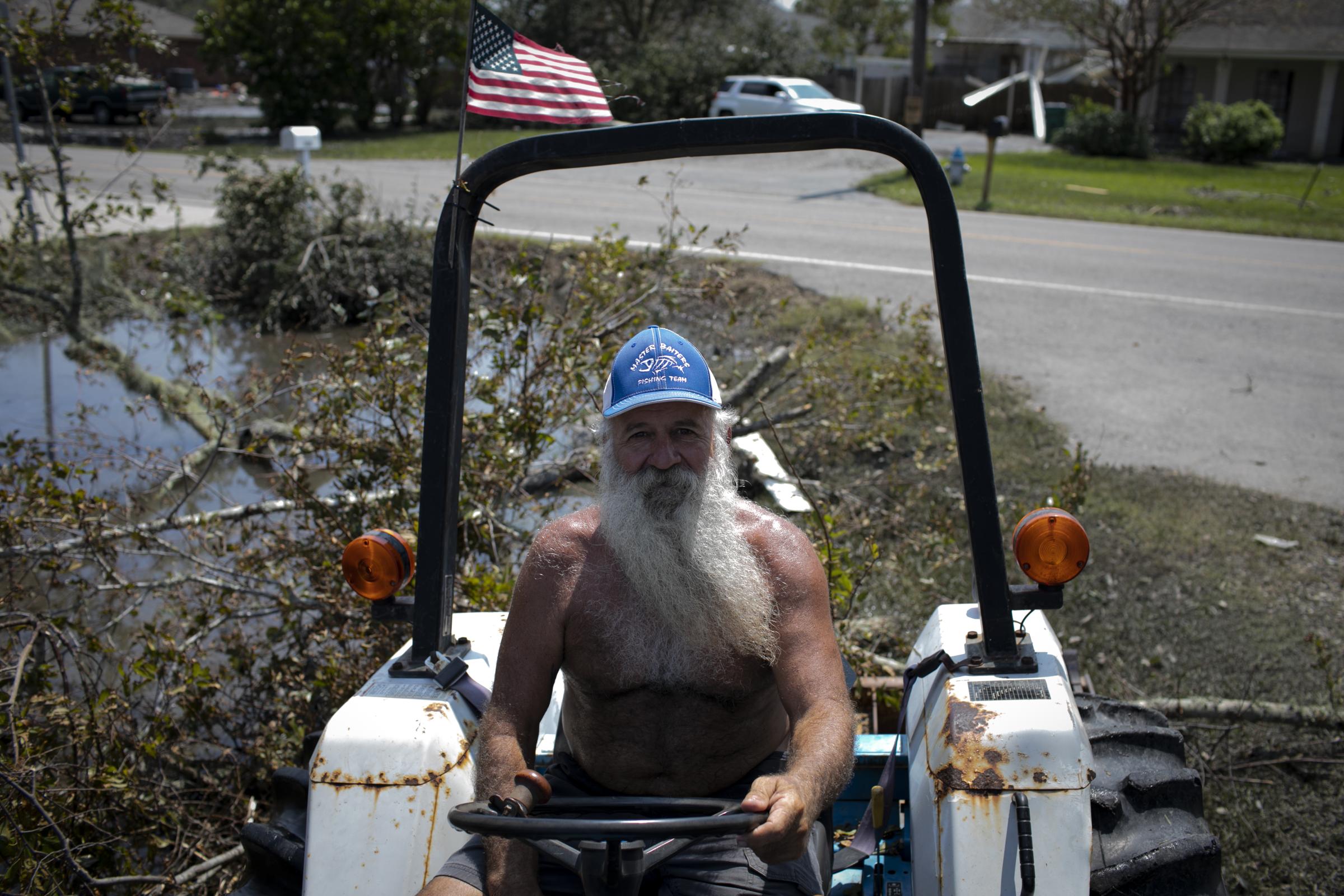 slideshow - Jay Casso poses for a photo as he cleans his property, in the aftermath of Hurricane Ida landfall...