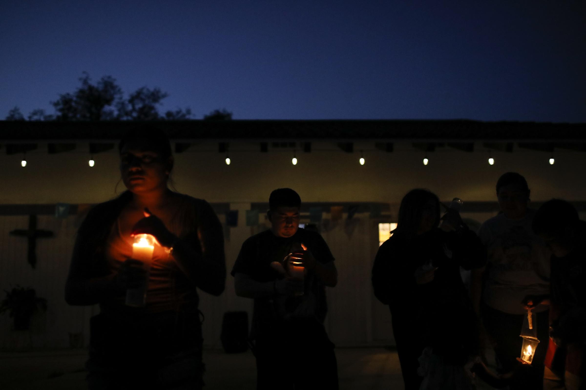 slideshow - People attend a vigil for the victims of the Robb Elementary school mass shooting that resulted...