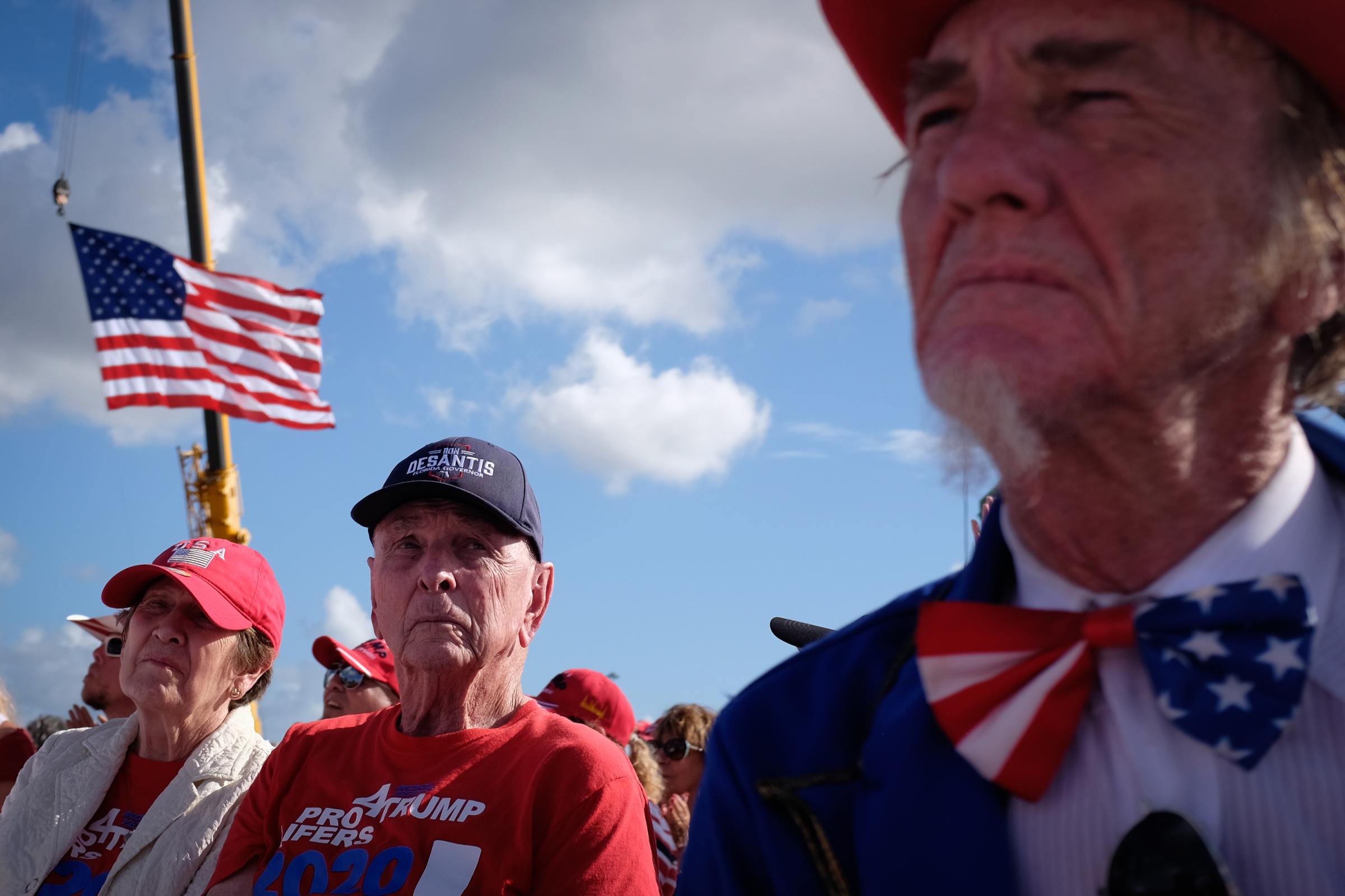 slideshow - Supporters of former U.S. president Donald Trump wait for him to speak during a rally ahead of...