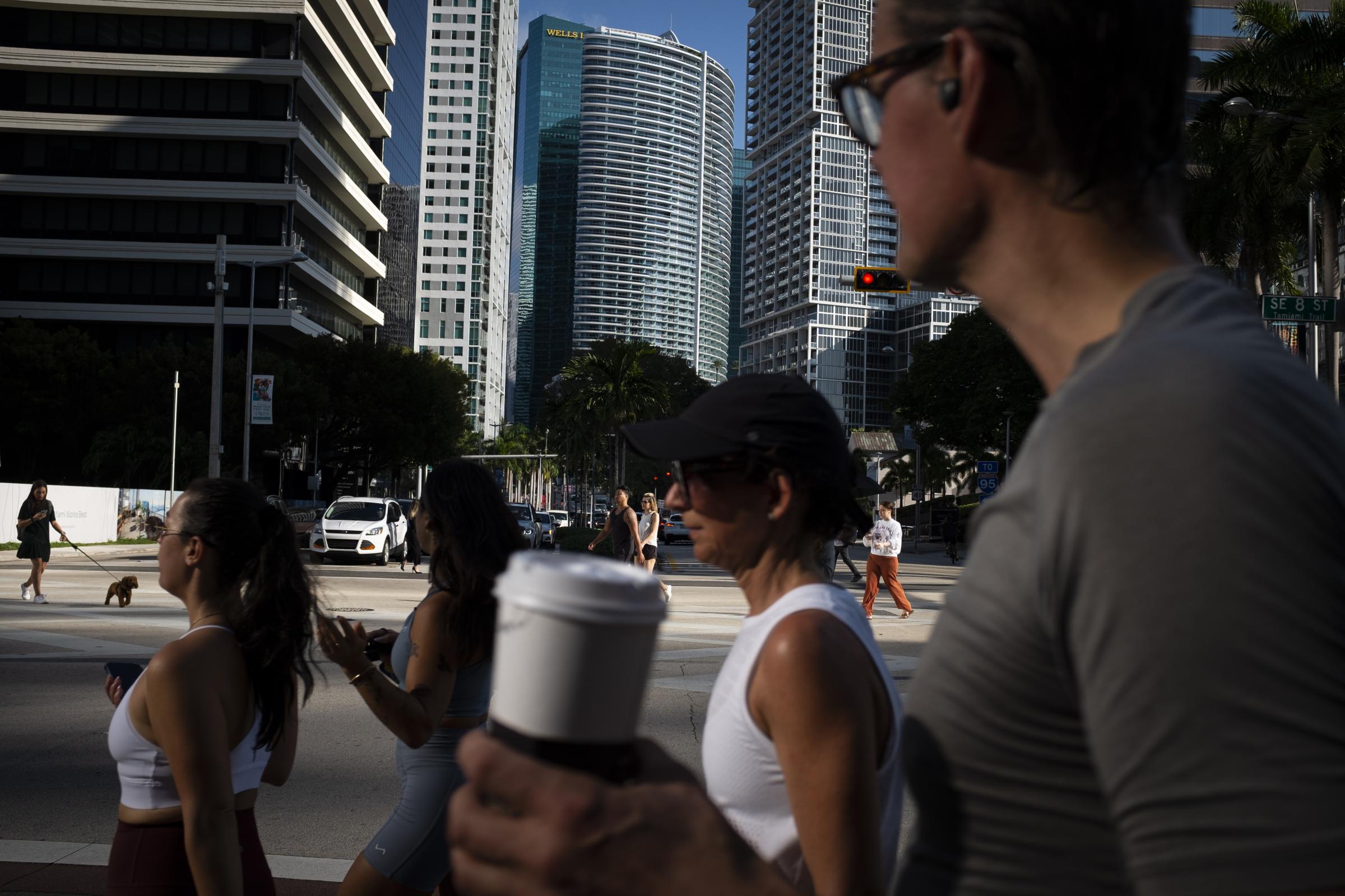 slideshow - People cross the intersection of SW 8th Steet and Brickell Ave. at the Brickell neighborhood,...