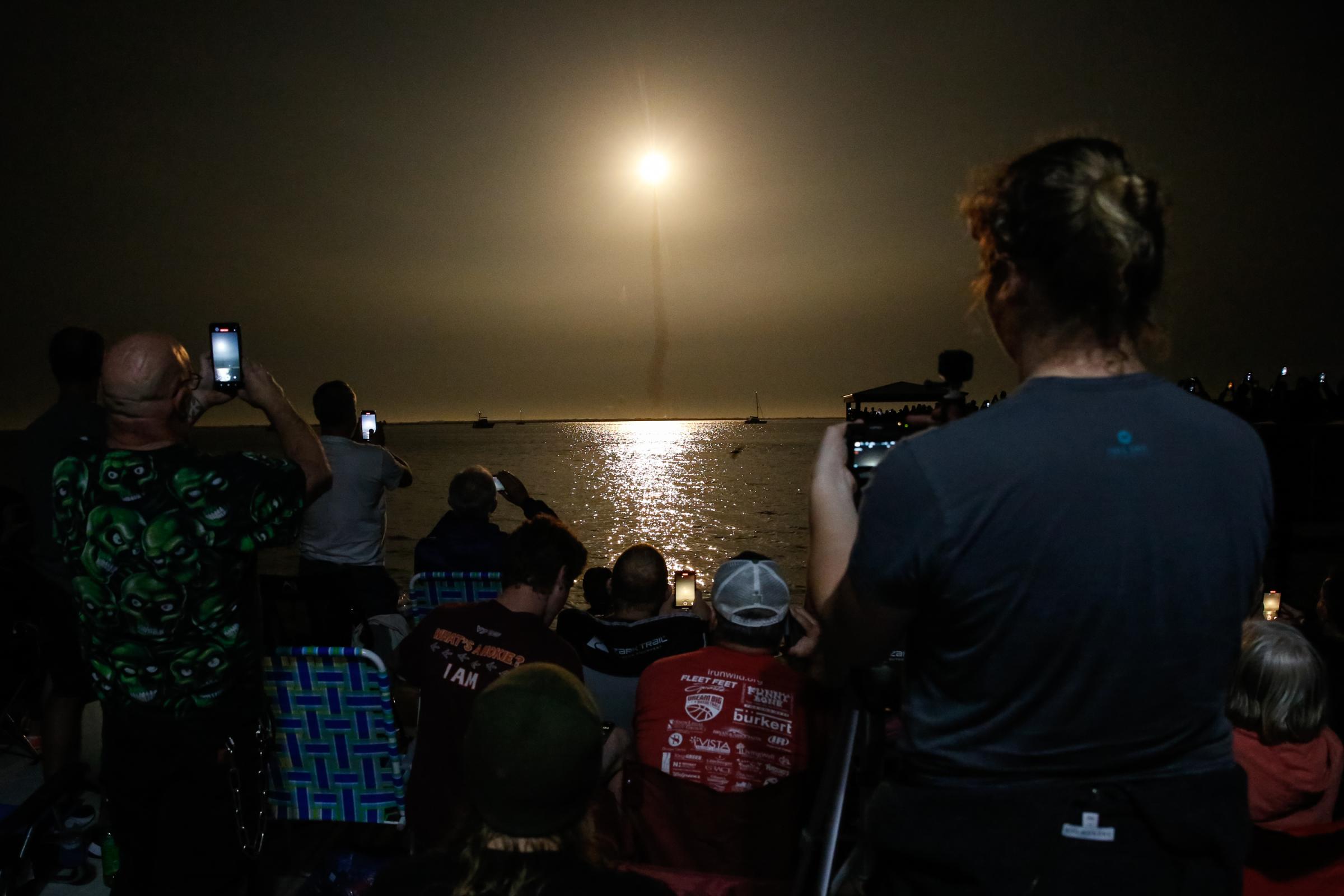 slideshow - People at Veterans Memorial park watch as the Artemis I unmanned lunar rocket lifts off from pad...