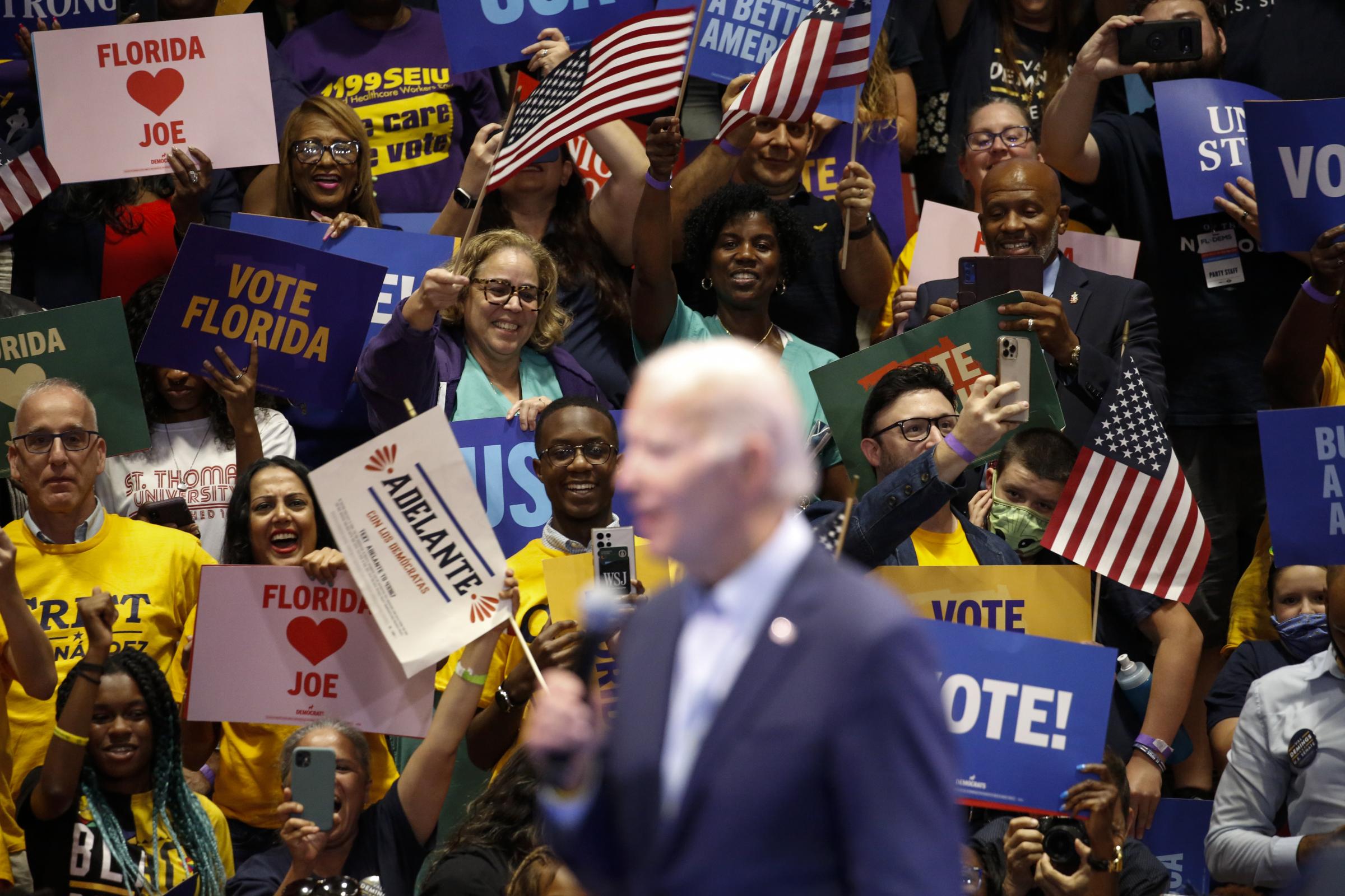 slideshow - People react as U.S. President Joe Biden takes the stage during a campaign rally for the...