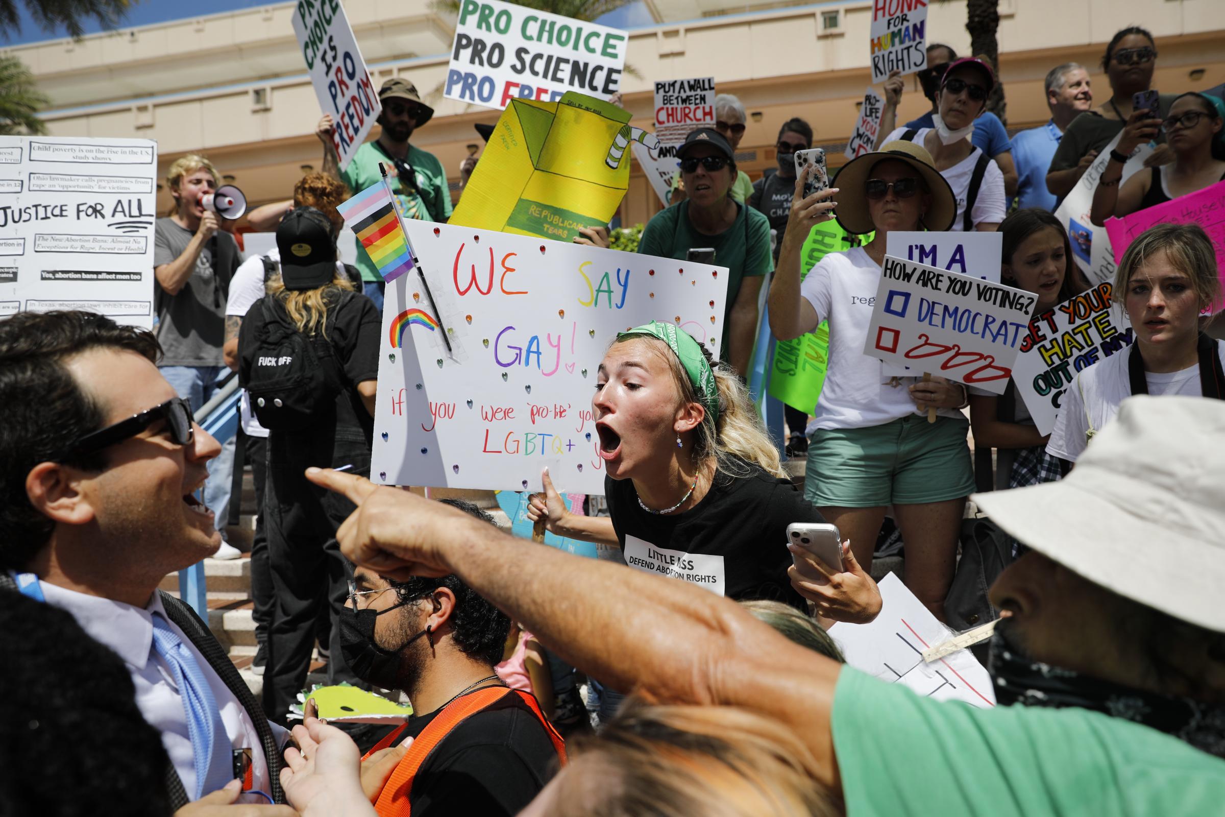 slideshow - A demonstrator argues with a conservative during a protest outside the Tampa Convention Center...