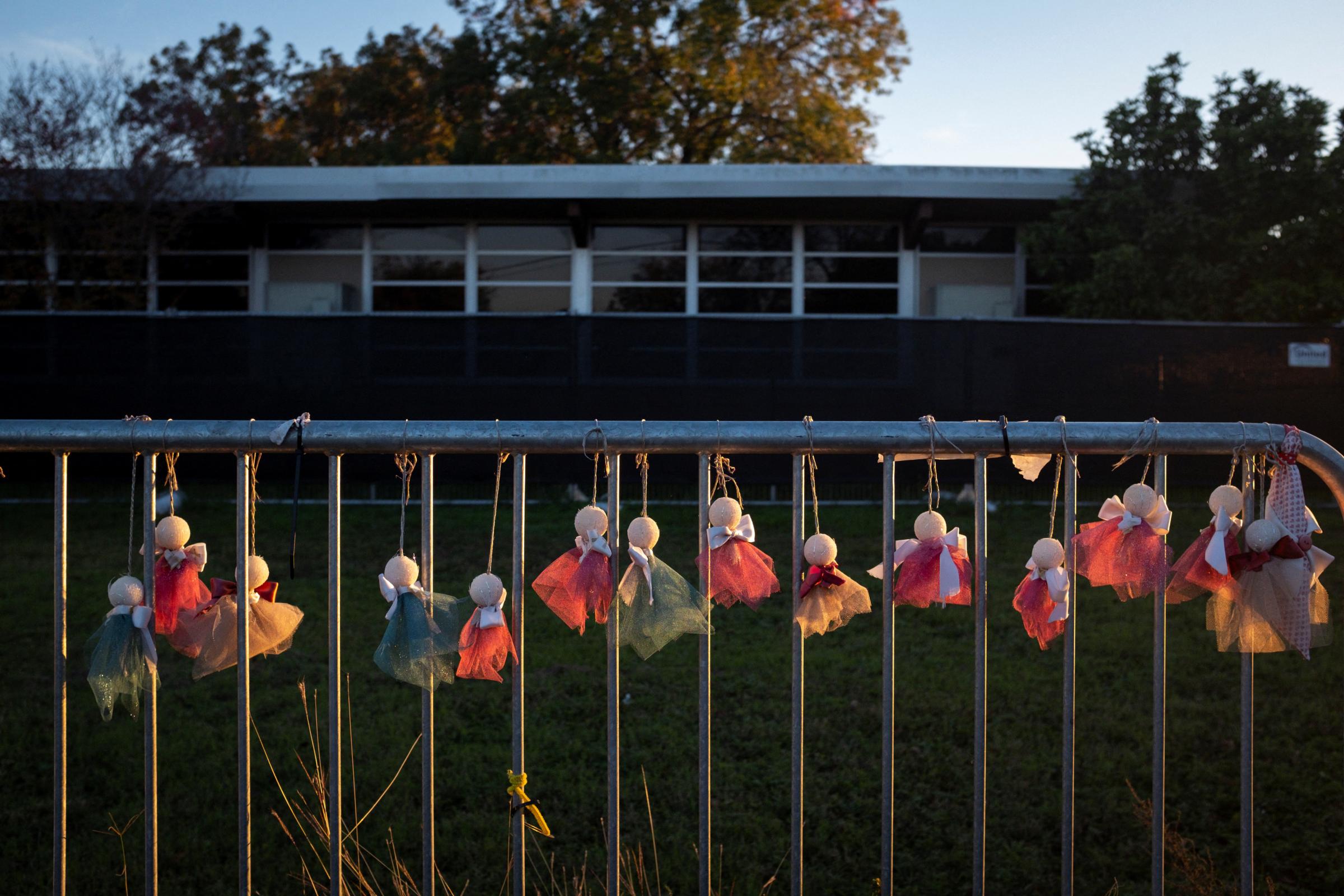 slideshow - Cloth angels are seen in a memorial outside Robb Elementary, where a gunman killed 19 children...