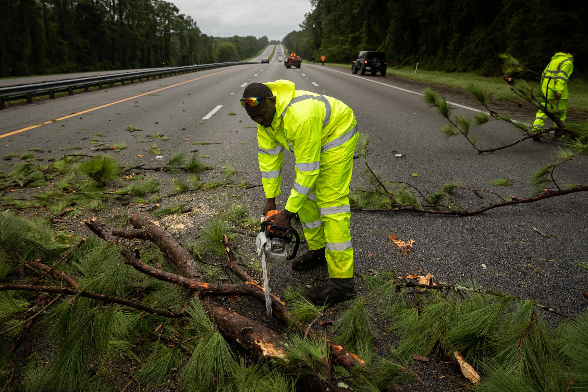 Hurricane Idalia hits Florida - Workers clean up a blockade at Interstate 75 (I-75)...