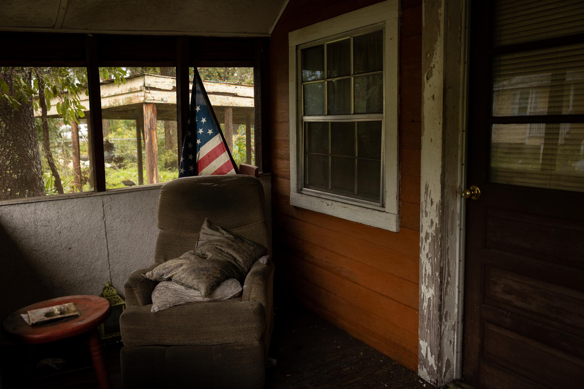 Hurricane Idalia hits Florida - An American flag is seen in a front porch of a house...