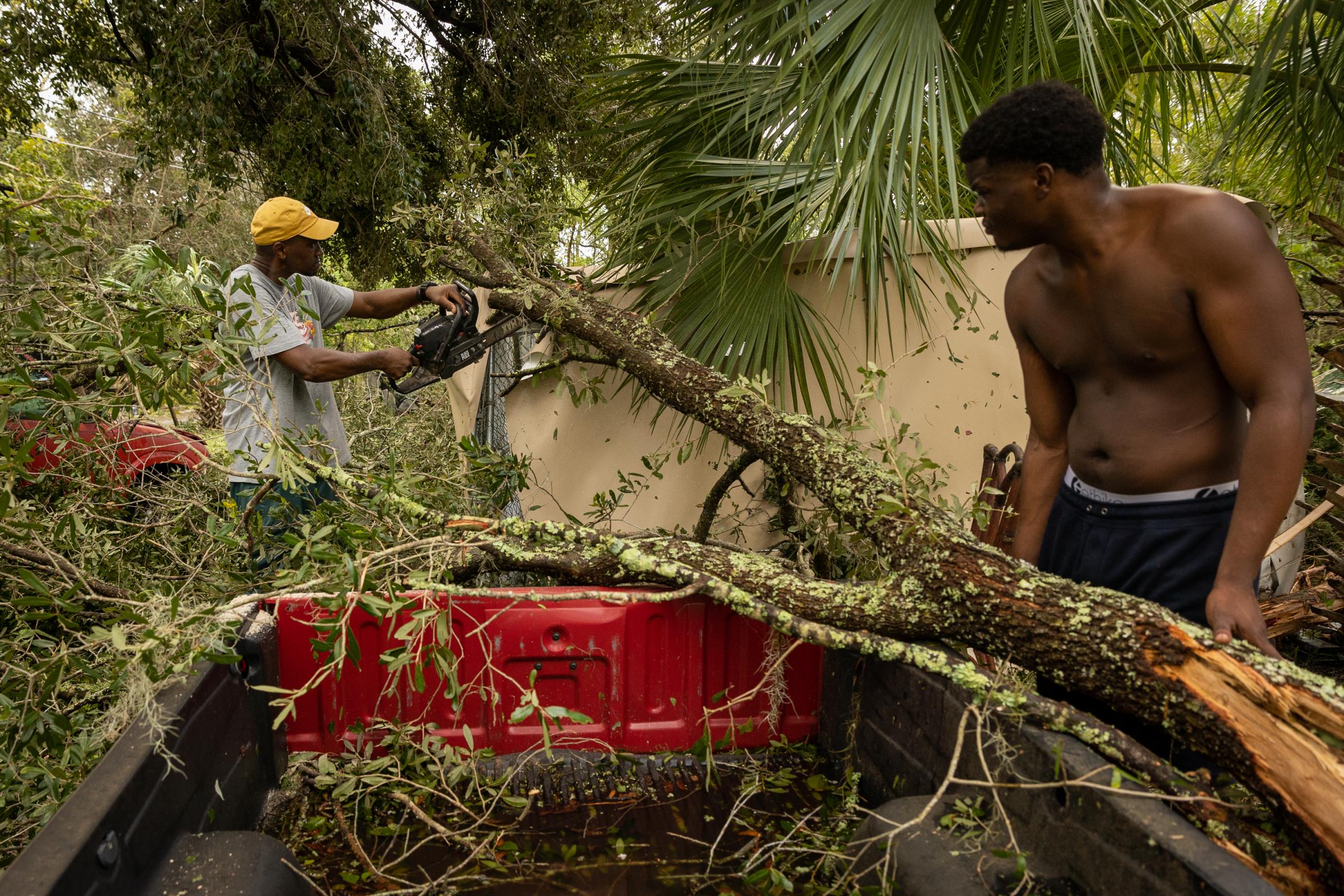 Hurricane Idalia hits Florida - People prune a fallen tree after the arrival of Hurricane...