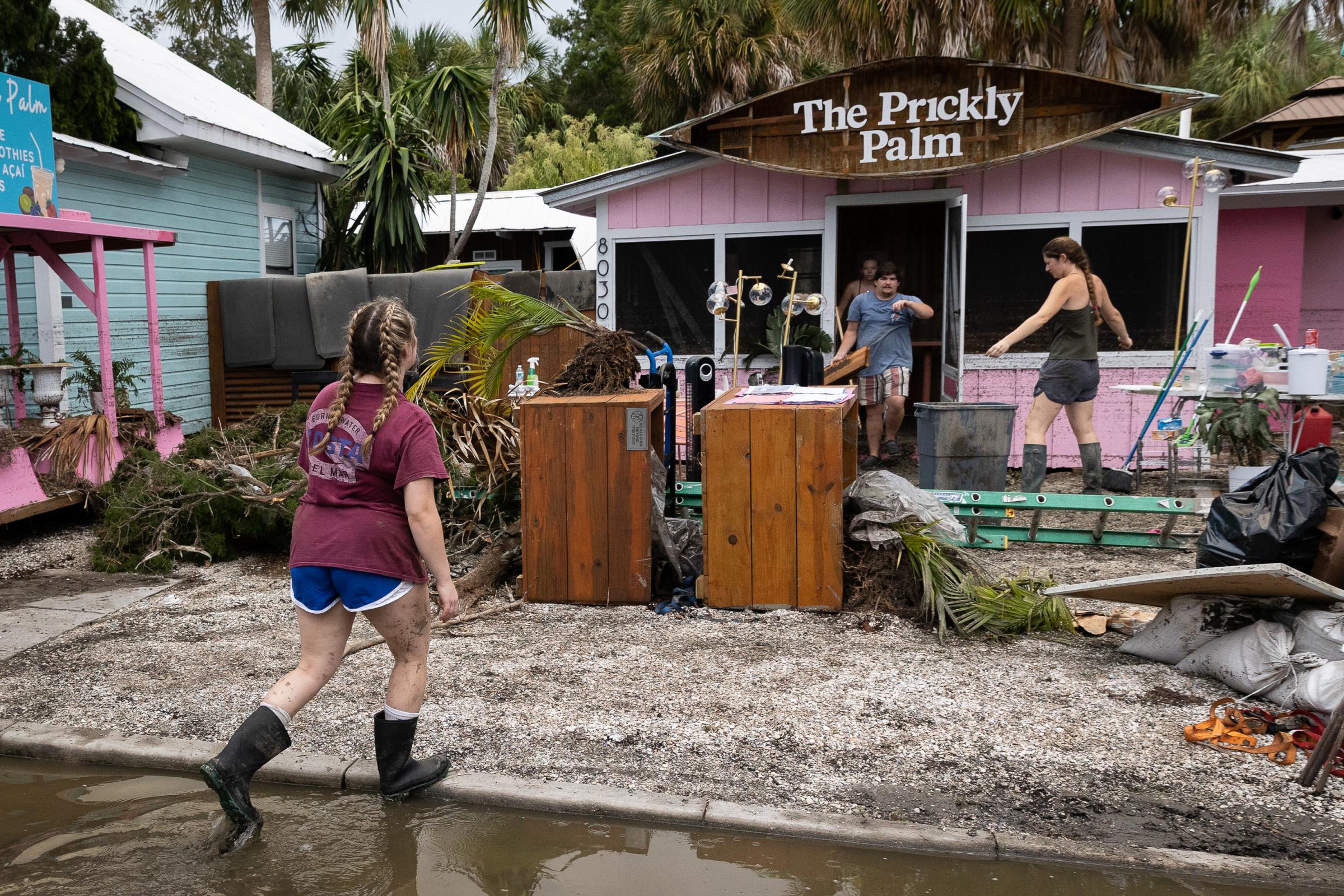 Hurricane Idalia hits Florida - People clean up a coffee shop after the arrival of...