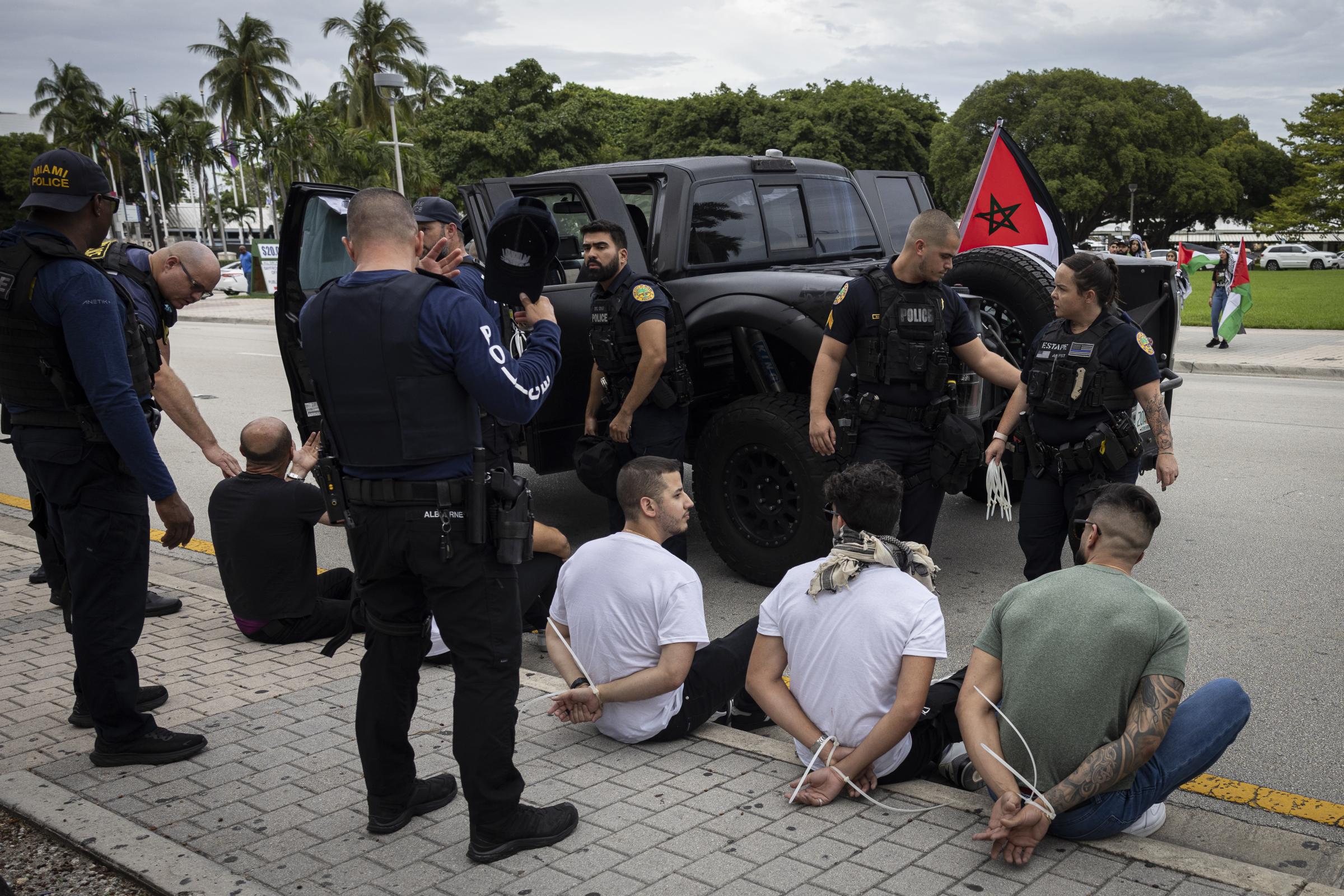 Pro-Palestine demonstration in Miami - Miami Police officers detain men as they arrive at a...