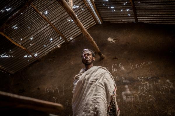 Amanuel Sileshi | Searching for Peace Amidst Chaos -  In Mesobit, Ethiopia, Hailemariam Girma, 21, looks at a...