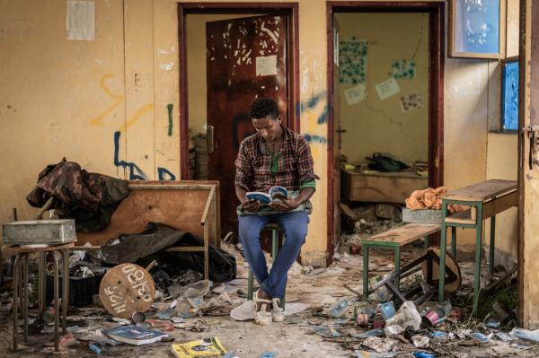 Amanuel Sileshi | Searching for Peace Amidst Chaos -  Kindu Fenta, 17, reads a book inside a classroom which...