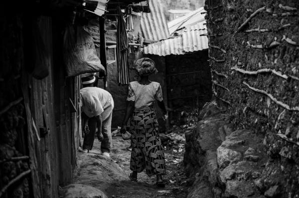 Image from Gordwin Odhiambo | A Changing Community and the Fears Ahead -  A resident walks along a narrow corridor in Kibera....