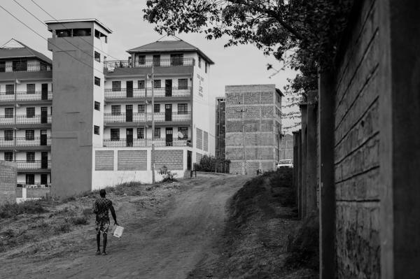 Image from Gordwin Odhiambo | A Changing Community and the Fears Ahead -  A wall separates new-built high rise buildings from...